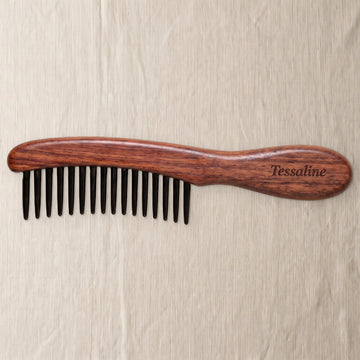 A wide-tooth detangling comb on natural linen