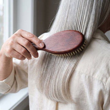The Soft Grade brush gliding through long, fine silver hair